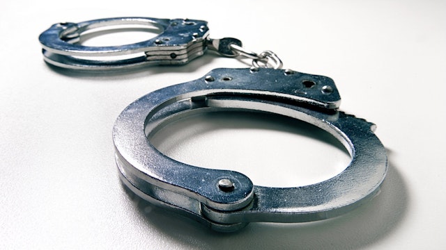 Handcuffs wide angle - stock photo handcuffs ATU Images via Getty Images