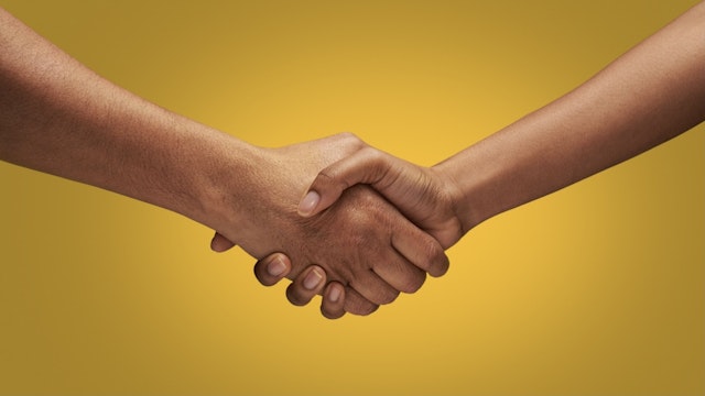 Close up of holding hands - stock photo Close up of man and woman holding hands in studio with yellow background Kelvin Murray via Getty Images