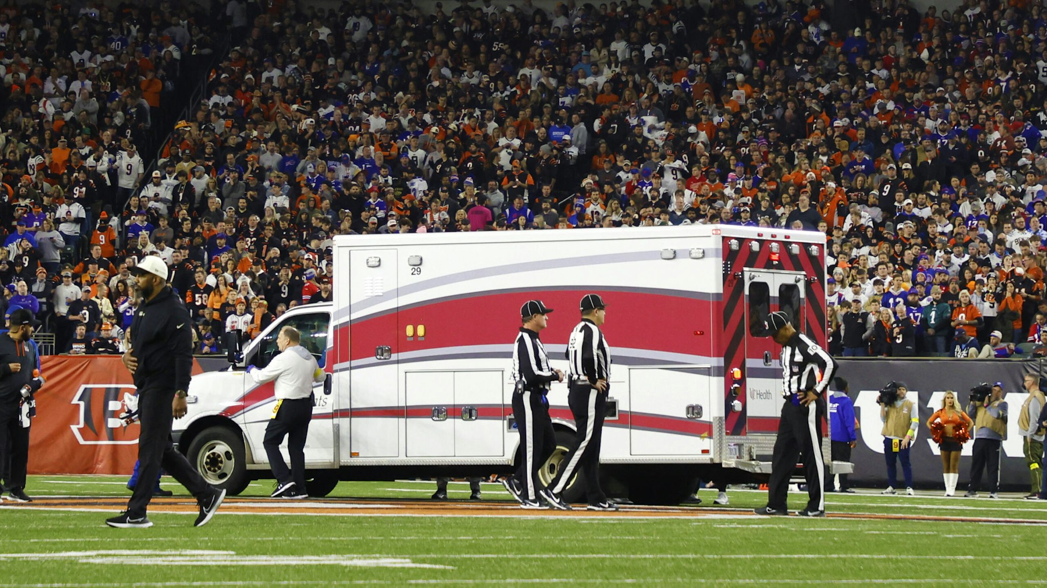 CINCINNATI, OHIO - JANUARY 02: Fans look on as the ambulance leaves carrying Damar Hamlin #3 of the Buffalo Bills after he collapsed after making a tackle against the Cincinnati Bengals during the first quarter at Paycor Stadium on January 02, 2023 in Cincinnati, Ohio.
