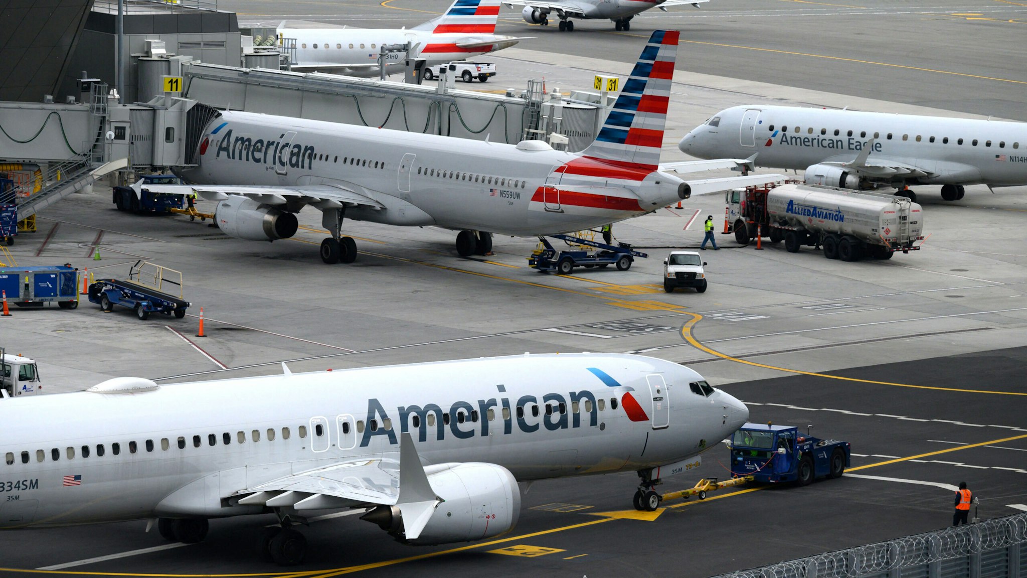 American Airlines airplanes sit on the tarmac at LaGuardia airport in New York on January 11, 2023. - The US Federal Aviation Authority said Wednesday that normal flight operations "are resuming gradually" across the country following an overnight systems outage that grounded departures.