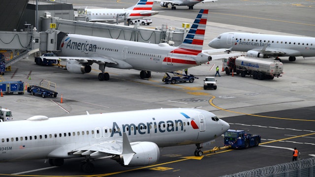 American Airlines airplanes sit on the tarmac at LaGuardia airport in New York on January 11, 2023. - The US Federal Aviation Authority said Wednesday that normal flight operations "are resuming gradually" across the country following an overnight systems outage that grounded departures.