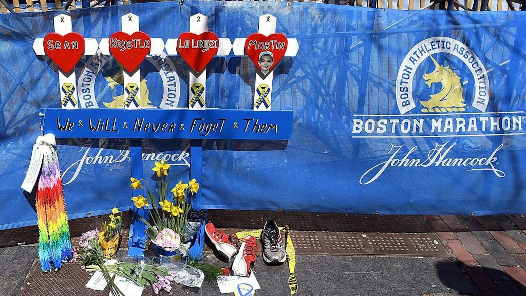 A makeshift memorial set up at the spot where the bomb went off near the finish line, on the eve of the 2014 Boston Marathon April 20, 2014 in Boston, Massachussetts. The Boston Marathon returns Monday under heavy security after last year's deadly bombings, as a near record 35,660 runners get set to compete. One million people are expected to line the route in a show of defiance and to honor the victims and survivors of the attacks which killed three people and wounded more than 260. AFP PHOTO / Timothy A. CLARY (Photo credit should read TIMOTHY A. CLARY/AFP via Getty Images)