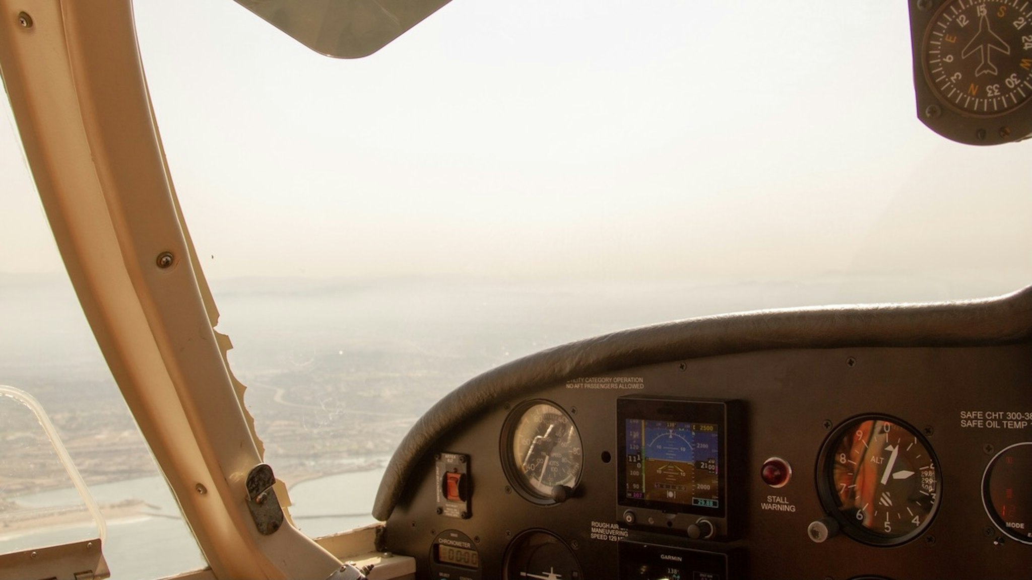 Pilot view from the cockpit of a single-engine, propellor airplane - stock photo View from cockpit over the coast of San Diego County, California. All logos removed. Raquel Lonas via Getty Images