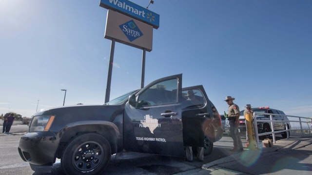 Texas State Troopers keep watch outside the Cielo Vista Mall Wal-Mart where a shooting left 20 people dead in El Paso, Texas, on August 4, 2019. - Texas authorities are investigating the Saturday mass shooting at a Walmart store in El Paso as a possible hate crime, the city's police chief said, as authorities study an online manifesto linked to the suspect.