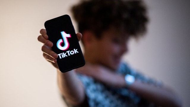 A teenager presents a smartphone with the logo of Chinese social network Tik Tok, on January 21, 2021 in Nantes, western France. (Photo by LOIC VENANCE / AFP) (Photo by LOIC VENANCE/AFP via Getty Images)