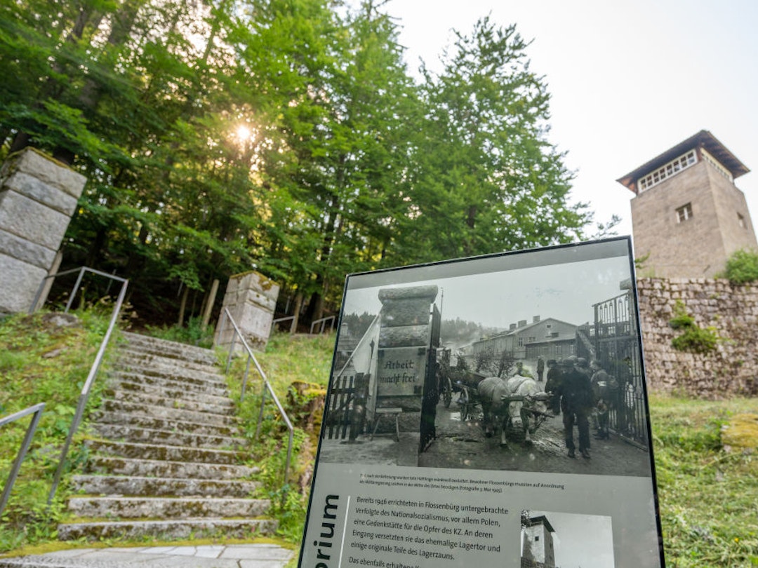 21 July 2021, Bavaria, Flossenbürg: An information board stands on the grounds of the Flossenbürg concentration camp memorial site in front of a former watchtower. Photo: Armin Weigel/dpa (Photo by Armin Weigel/picture alliance via Getty Images)