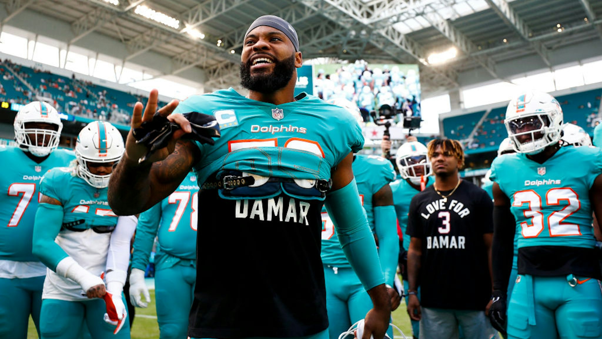 MIAMI GARDENS, FL - JANUARY 8: Elandon Roberts #52 of the Miami Dolphins gives a speech in the team huddle while wearing a shirt in honor of Damar Hamlin of the Buffalo Bills prior to an NFL football game against the New York Jets at Hard Rock Stadium on January 8, 2023 in Miami Gardens, Florida. (Photo by Kevin Sabitus/Getty Images)