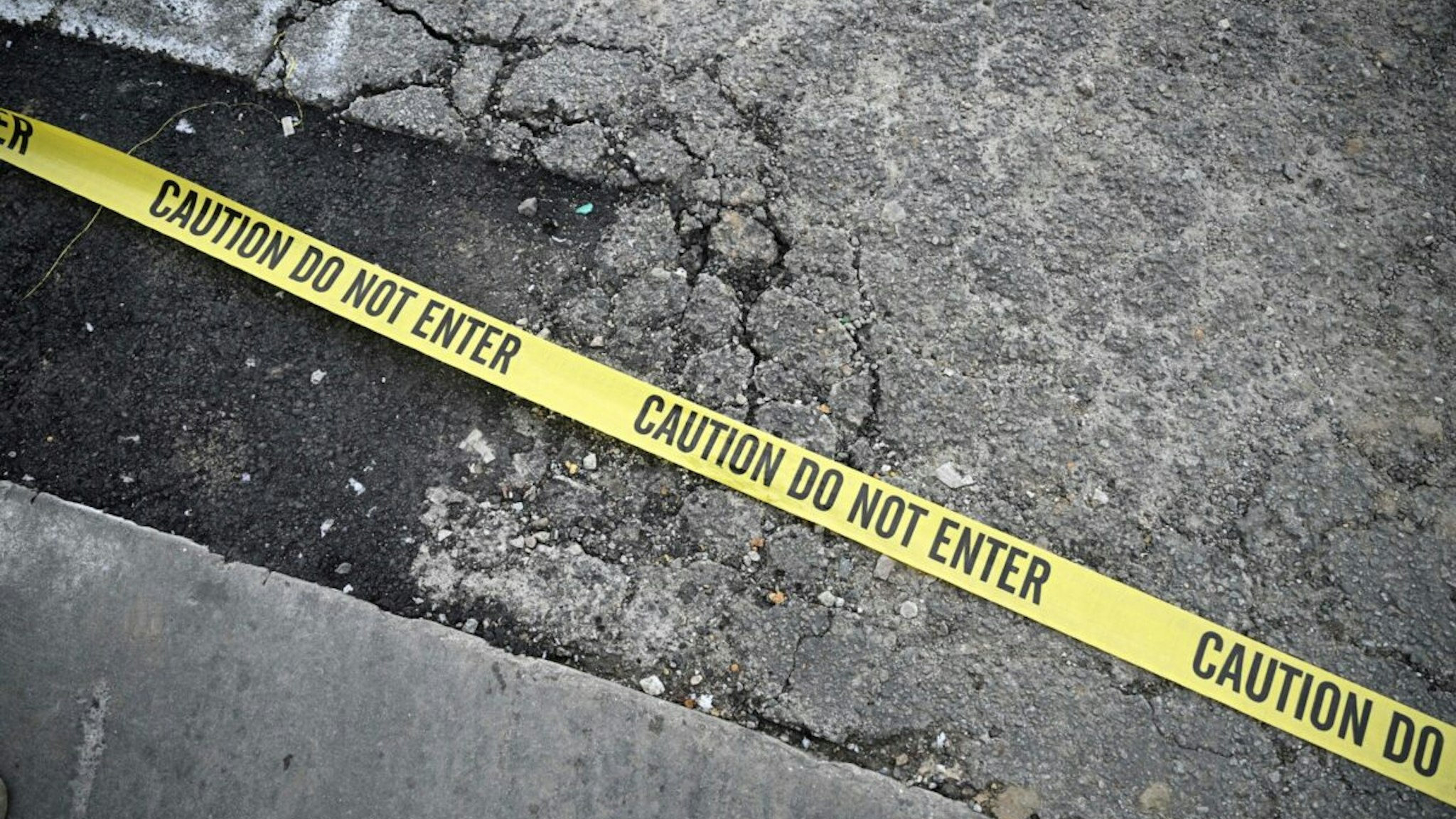 Police tape is seen on the ground at the scene of a mass shooting in Monterey Park, California, on January 22, 2023.