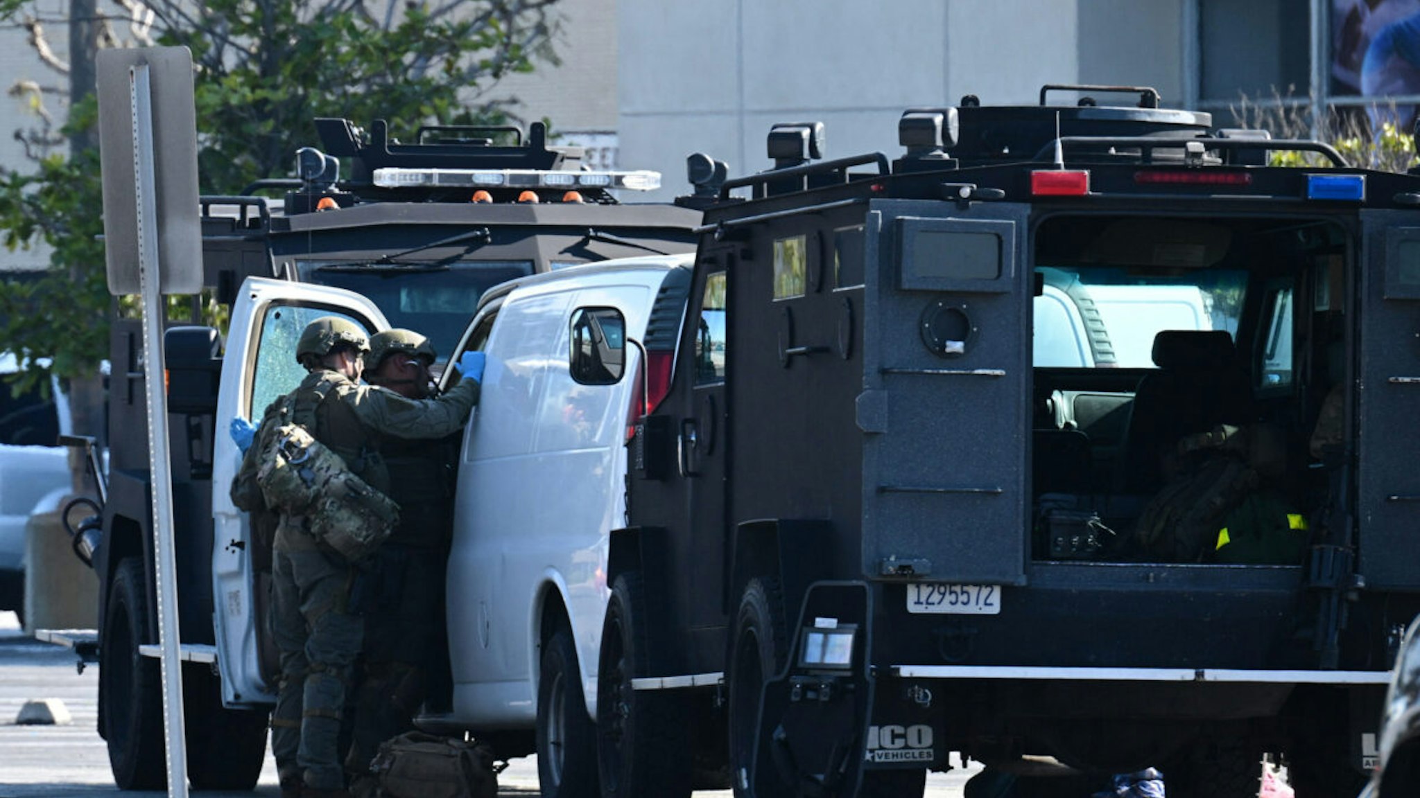 Law enforcement personnel open the door of a van outside the site in Torrance, California, where the alleged suspect in the mass shooting in which 10 people were killed in Monterey Park, California, is believed to be holed up on January 22, 2023.