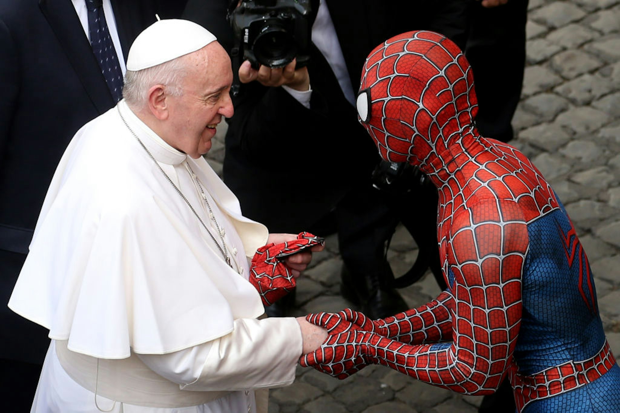 VATICAN CITY, VATICAN - JUNE 23: Pope Francis greets Mattia Villardita, a young man in the Spider-Man costume who makes children smile in the pediatric wards of hospitals, during his general audience at the courtyard of San Damaso on June 23, 2021 in Vatican City, Vatican. (Photo by
