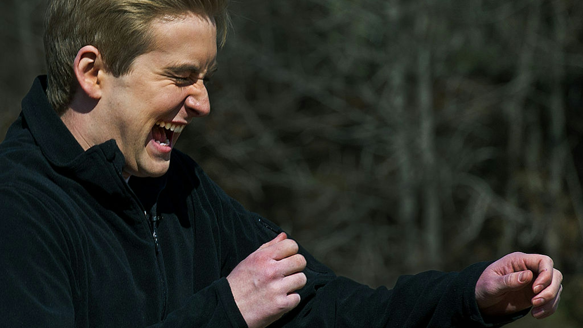 FOX Network television reporter Peter Doocy reacts as he is targeted with the Active Denial System, March 9th, 2012, at the US Marine Corps Base Quantico, Virginia. It is a US DoD non-lethal weapon that uses directed energy and projects a beam of man-sized millimeter waves up to 1000-meters that when fired at a human, delivers a heat sensation to the skin and generally makes humans stop what they are doing and run. AFP Photo/Paul J. Richards (Photo credit should read PAUL J. RICHARDS/AFP via Getty Images)
