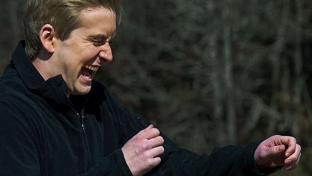 FOX Network television reporter Peter Doocy reacts as he is targeted with the Active Denial System, March 9th, 2012, at the US Marine Corps Base Quantico, Virginia. It is a US DoD non-lethal weapon that uses directed energy and projects a beam of man-sized millimeter waves up to 1000-meters that when fired at a human, delivers a heat sensation to the skin and generally makes humans stop what they are doing and run. AFP Photo/Paul J. Richards (Photo credit should read PAUL J. RICHARDS/AFP via Getty Images)