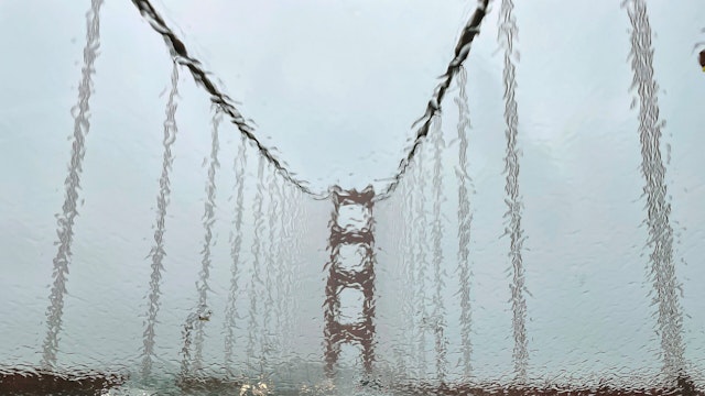 SAN FRANC, CALIFORNIA - JANUARY 04: The Golden Gate Bridge is seen through a rain covered windshield on January 04, 2023 in San Francisco, California. A massive storm is hitting Northern California bringing flooding rains and damaging wind