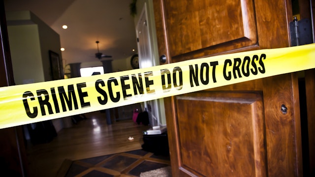 Crime Scene tape at the front door of a luxury home