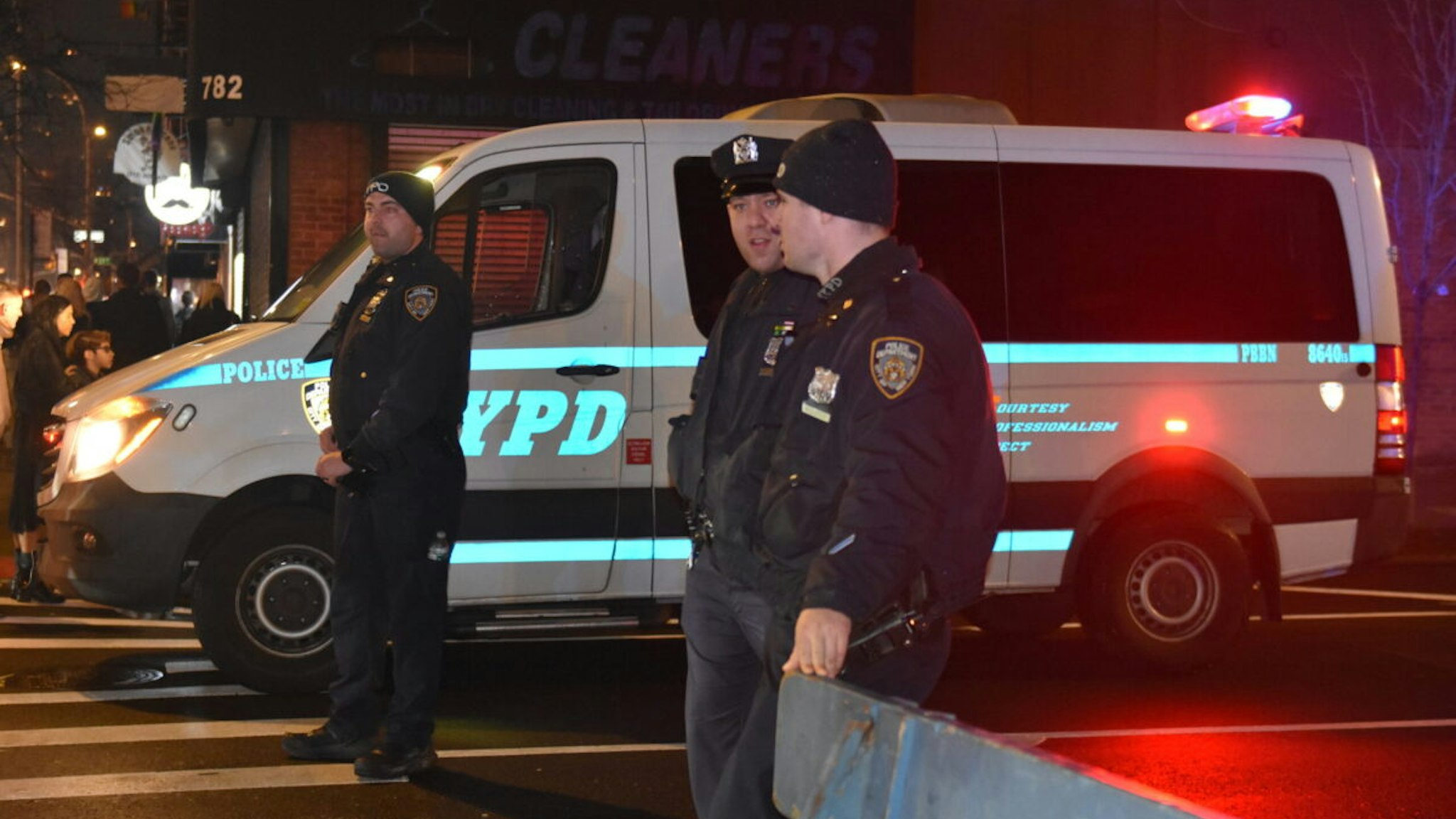 Police officers stand guard on a road after a 19-year-old assailant attacked three NYPD officers with a machete near Times Square during the new year celebrations in New York, United States on December 31, 2022