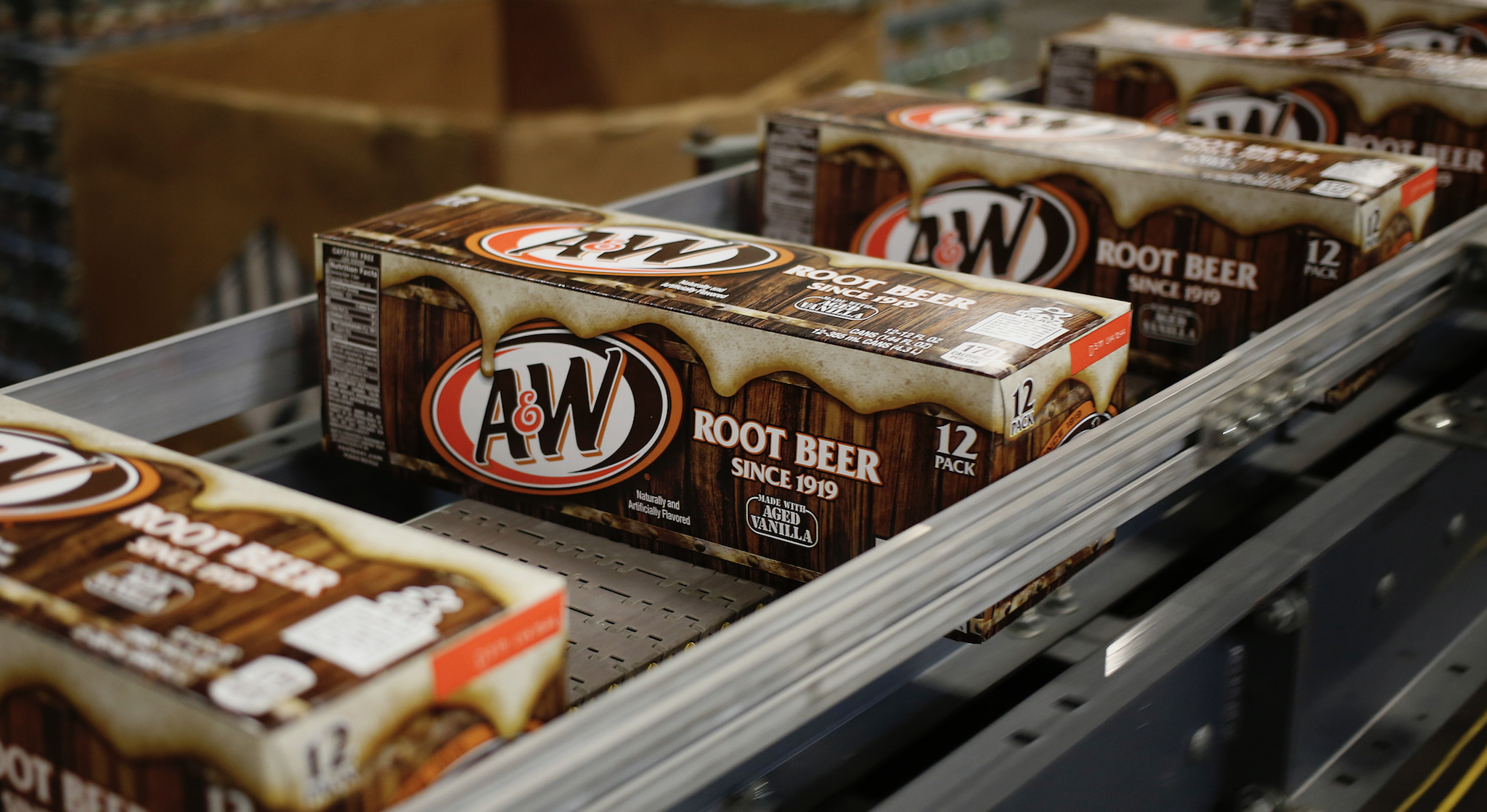 Cases of canned A&W Root Beer move down a conveyor belt after being filled at the Dr. Pepper Snapple Group Inc. bottling plant in Louisville, Kentucky, U.S., on Tuesday, April 21, 2015. Dr. Pepper Snapple Group Inc., producers of 7up and A&W Root Beer, is scheduled to release earnings figures on April 23.