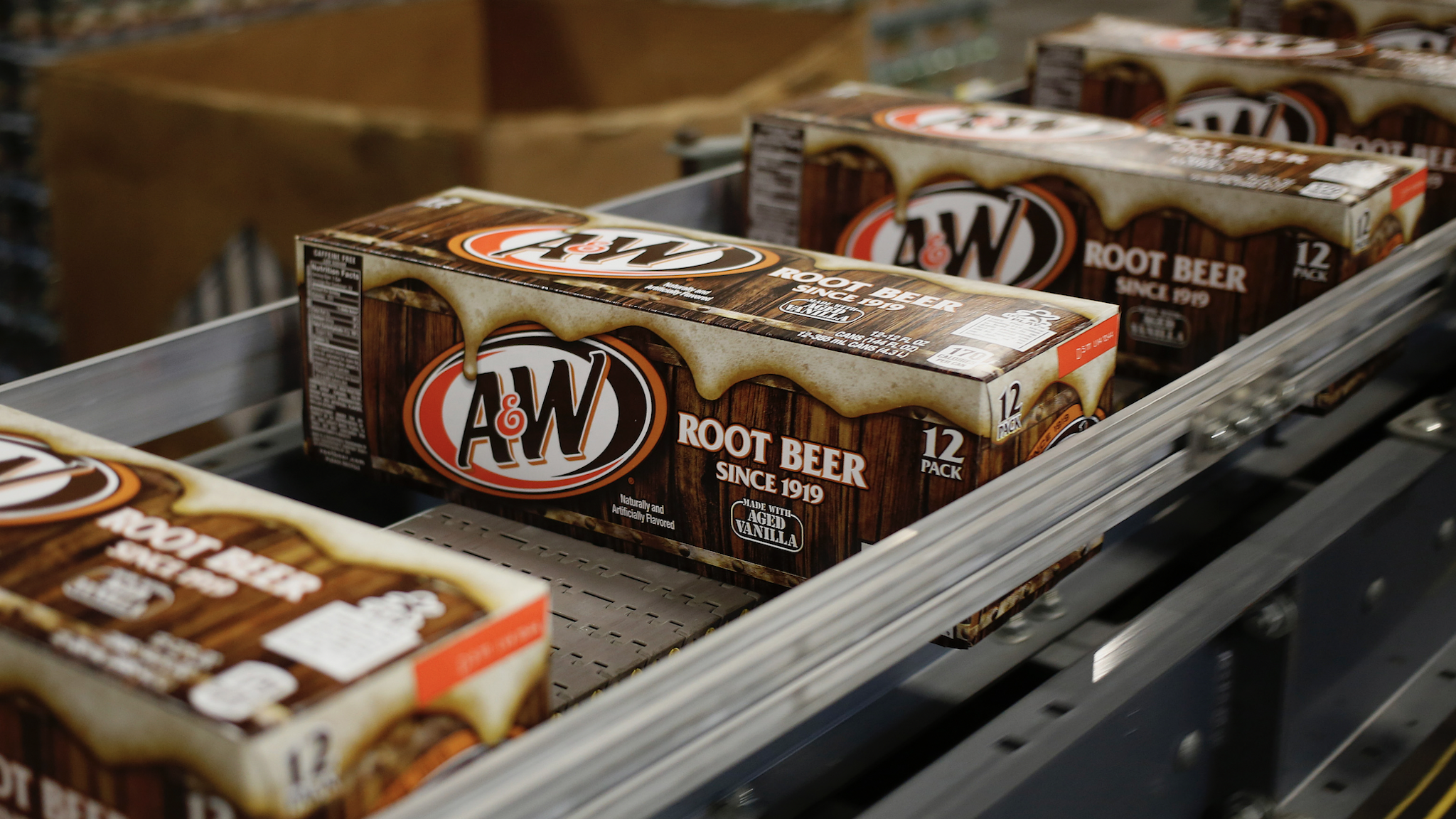 Cases of canned A&W Root Beer move down a conveyor belt after being filled at the Dr. Pepper Snapple Group Inc. bottling plant in Louisville, Kentucky, U.S., on Tuesday, April 21, 2015. Dr. Pepper Snapple Group Inc., producers of 7up and A&W Root Beer, is scheduled to release earnings figures on April 23.