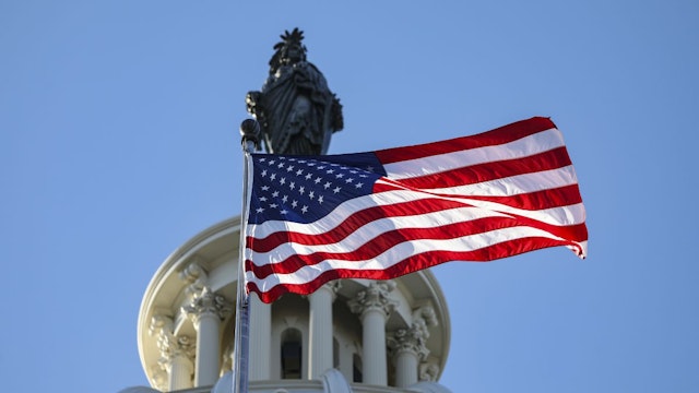 American flags and United States Capitol building are seen in Washington D.C., United States on December 28, 2022.