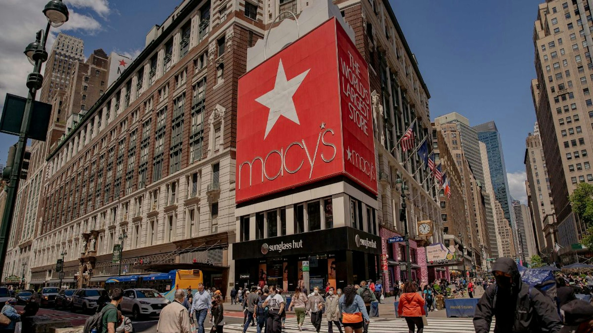 Pedestrians pass in front of Macy's Inc. flagship department store in the Herald Square area of New York, U.S., on Thursday, May 13, 2021.