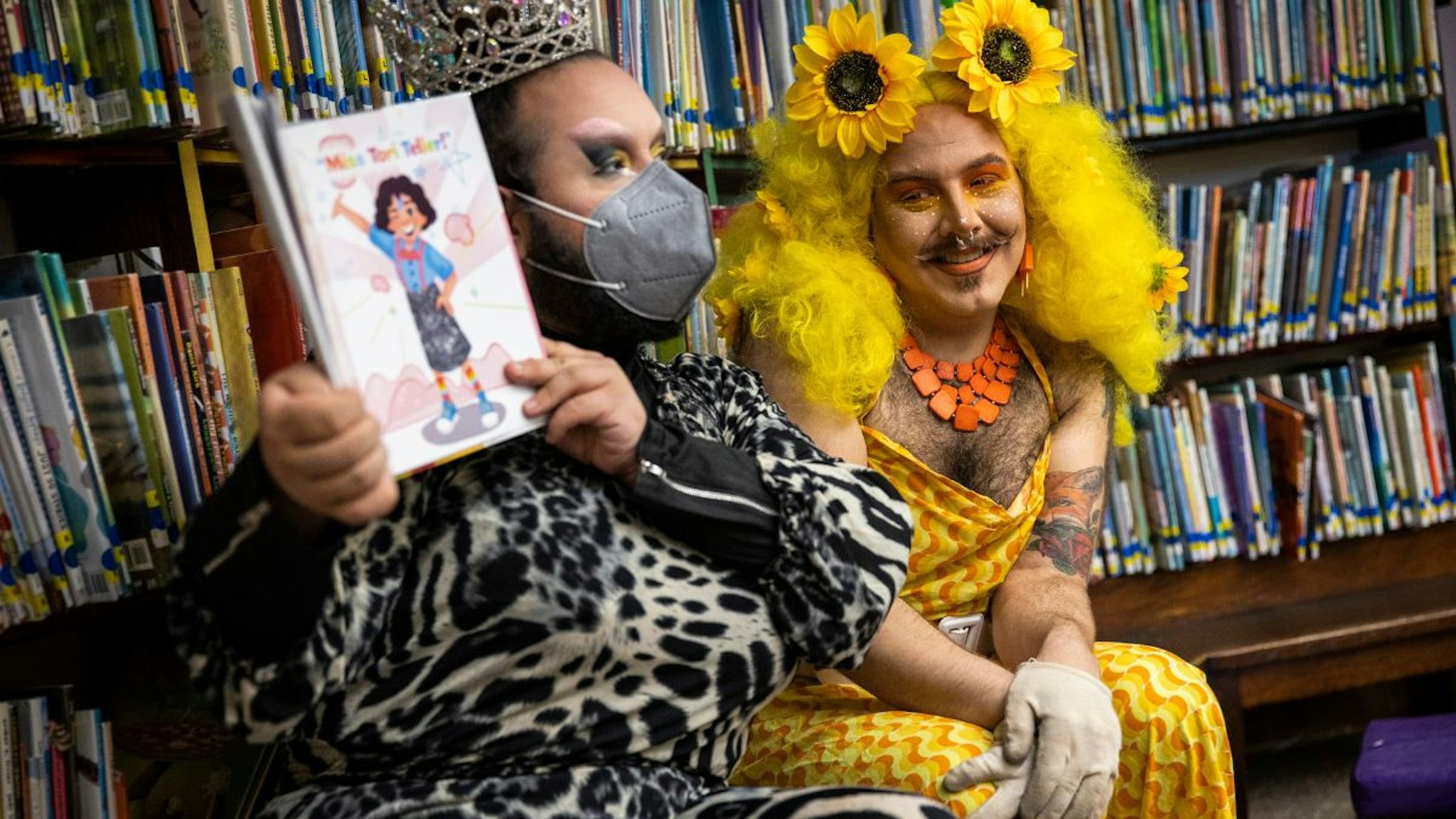 Drag queens Just JP, left, and Sham Payne read stories to children during a Drag Story Hour at Chelsea Public Library in Chelsea, MA on June 25, 2022.