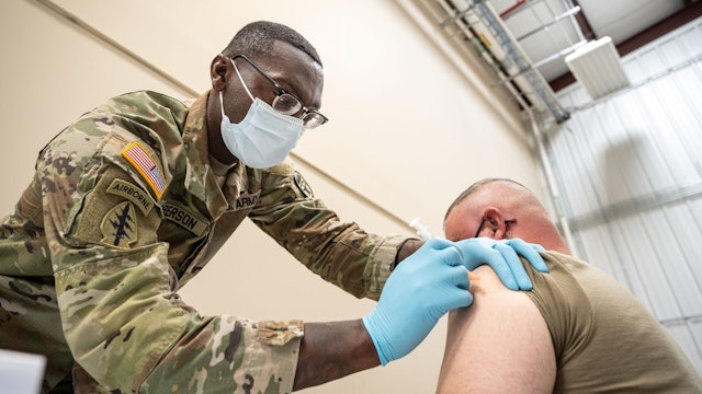 FORT KNOX, KY - SEPTEMBER 09: Preventative Medicine Services NCOIC Sergeant First Class Demetrius Roberson administers a COVID-19 vaccine to a soldier on September 9, 2021 in Fort Knox, Kentucky. The Pentagon, with the support of military leaders and U.S. President Joe Biden, mandated COVID-19 vaccination for all military service members in early September. The Pentagon stresses inoculation from COVID-19 and other diseases to avoid outbreaks from impeding the fighting force of the US Military.