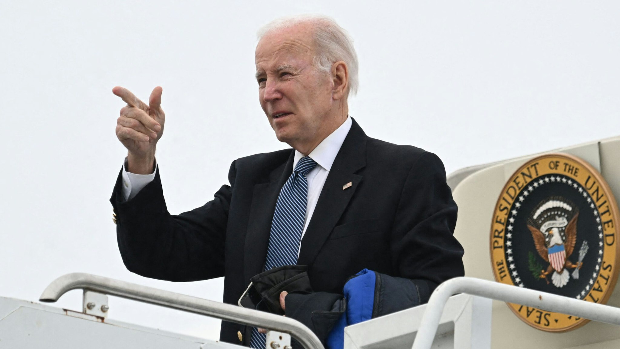 US President Joe Biden boards Air Force One at Hancock Field Air National Guard Base in Syracuse, New York, on February 4, 2023. - President Biden is headed to the Camp David presidential retreat in Maryland.