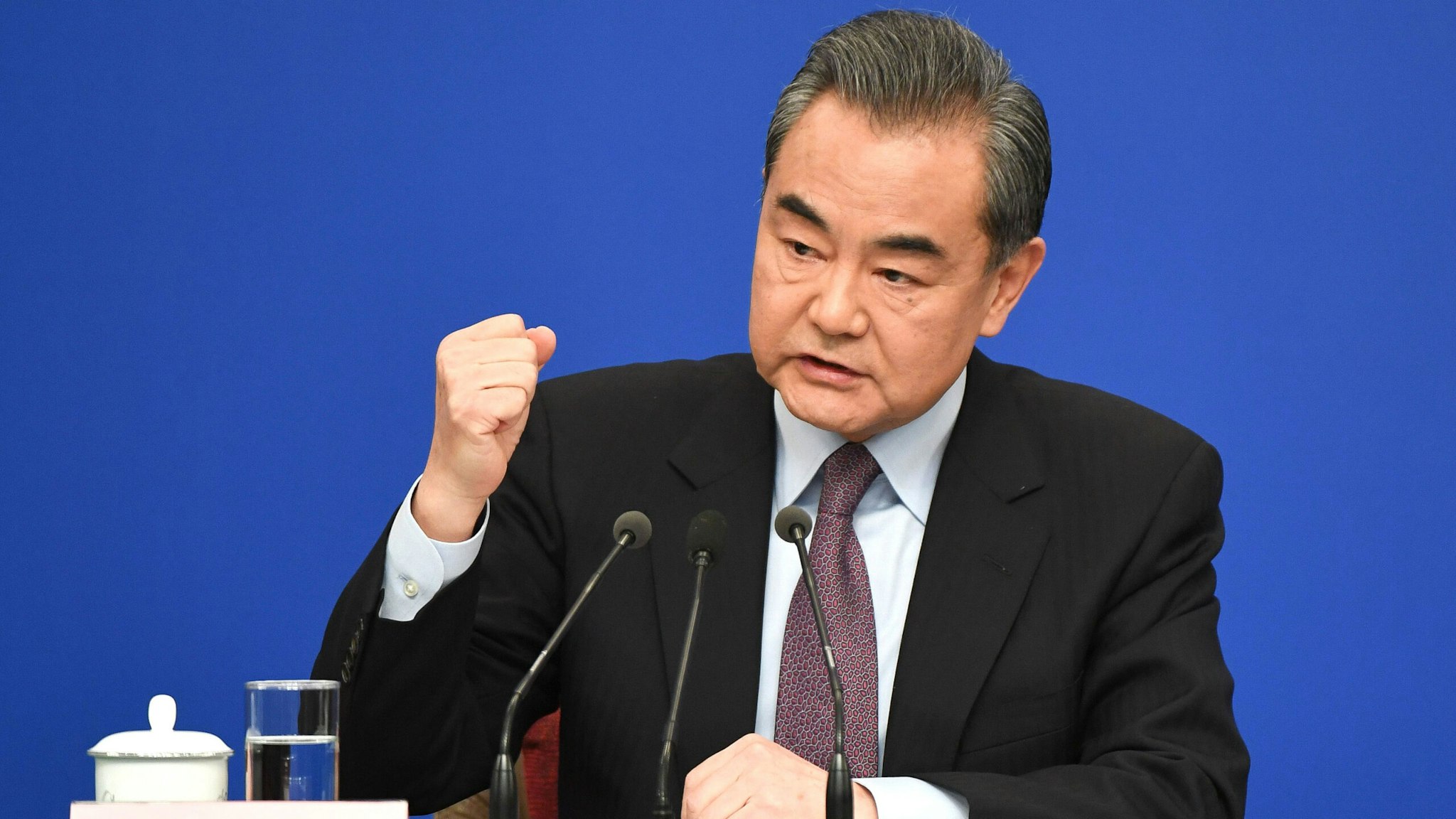 TOPSHOT - China's Foreign Minister Wang Yi reacts as he answers a question during a National People's Congress press conference in Beijing on March 8, 2019. - China threw its weight behind Huawei's legal battle against the United States on March 8, vowing to take all necessary measures to defend the "legitimate rights" of Chinese companies and individuals.