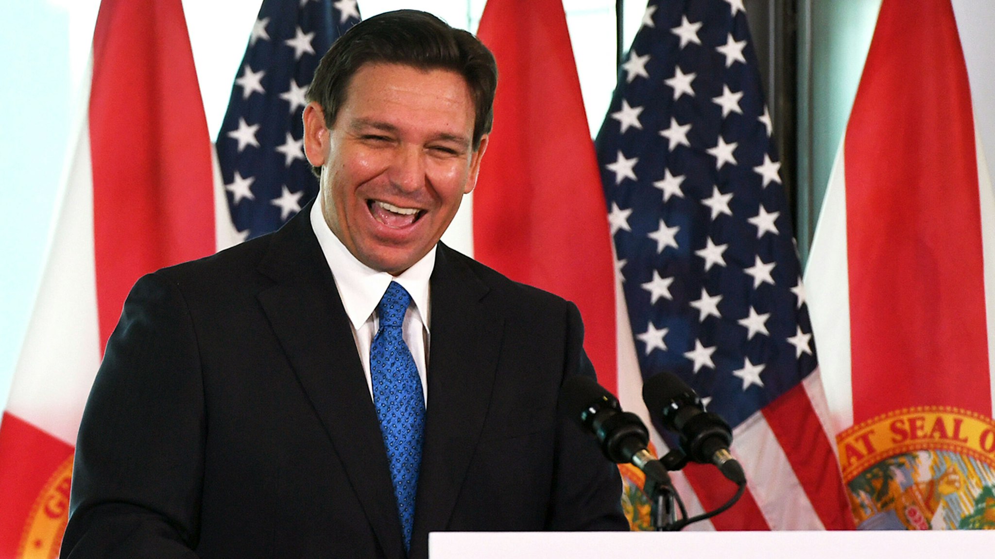 AUBURNDALE, FLORIDA, UNITED STATES - 2023/01/30: Florida Gov. Ron DeSantis laughs during a press conference to announce the Moving Florida Forward initiative at the SunTrax Test Facility in Auburndale, Florida. If passed by the legislature, the proposal would expedite transportation projects over the next four years with $7 billion in funding.