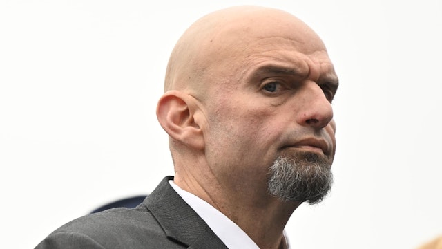 HARRISBURG, PA - JANUARY 17: U.S. Senator John Fetterman (D-PA) and his wife, Gisele Barreto Fetterman, stand during the singing of the National Anthem before Josh Shapiro was sworn in as Governor of Pennsylvania at the State Capitol Building on January 17, 2023 in Harrisburg, Pennsylvania. Shapiro defeated Republican nominee Doug Mastriano by nearly 15 percent in the November election.