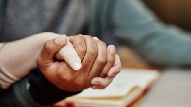 Holding hands in prayer