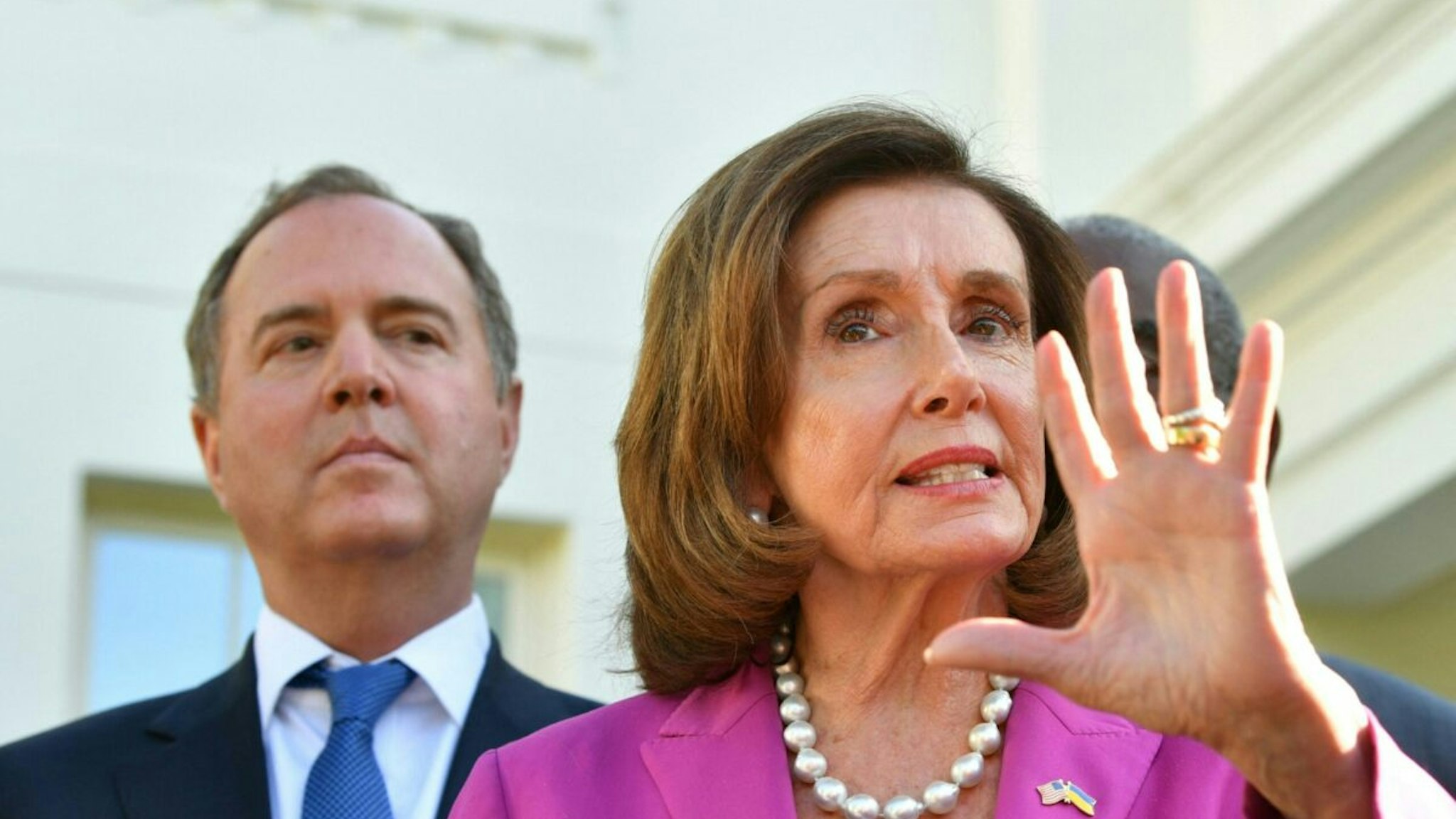 US Representative Adam Schiff (D-CA) (L) listens as US Speaker of the House Nancy Pelosi, alongside members of the Congressional delegation that recently visited Ukraine, speaks to reporters following a meeting with US President Joe Biden at the White House in Washington, DC, on May 10, 2022.