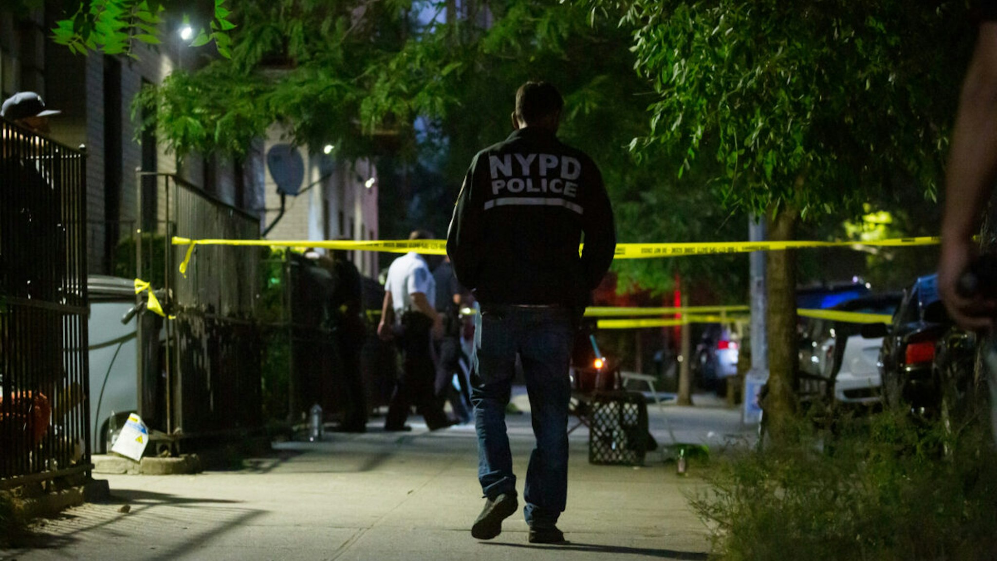 New York Police Department (NYPD) officers investigate the scene of a shooting in the Crown Heights neighborhood in the Brooklyn borough of New York, U.S., on Thursday, July 21, 2022.