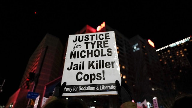 A protestor holds a sign reading "Justice for Tyre Nichols, Jail Killer Cops" during a rally against the fatal police assault of Tyre Nichols, in Atlanta, on January 27, 2023.