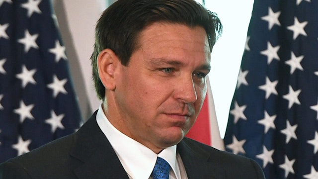 Florida Gov. Ron DeSantis listens during a press conference to announce the Moving Florida Forward initiative at the SunTrax Test Facility in Auburndale.