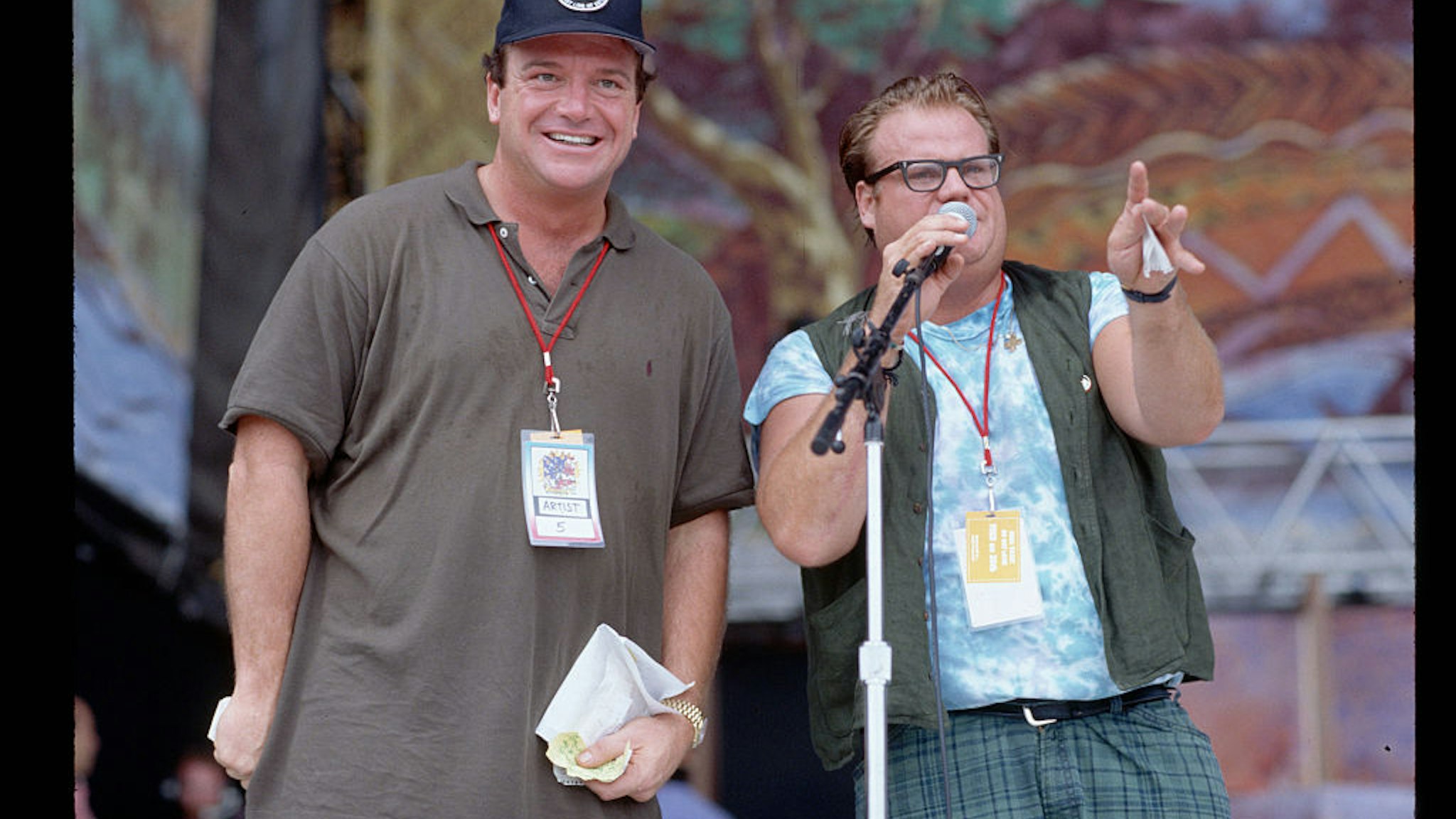 (Original Caption) : 8/1994-Photo shows Chris Farley and Tom Arnold on the stage at the 25th Anniversary concert for the celebration of the original Woodstock concert, which took place in August, 1969. (Photo by Lynn Goldsmith/Corbis/VCG via Getty Images)