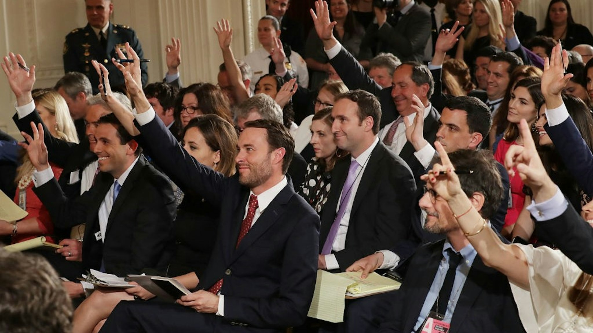 WASHINGTON, DC - MAY 18: Reporters raise their hands to ask questions during a news conference with Colombian President Juan Manuel Santos and U.S. President Donald Trump in the East Room of the White House May 18, 2017 in Washington, DC. The Trump administration has said it wants to slash foreign aide and Santos will most likely seek a renewal of $450 million dollars from the U.S. that supports the peace accord between the Columbian government at the Revolutionary Armed Forces (FARC). (Photo by