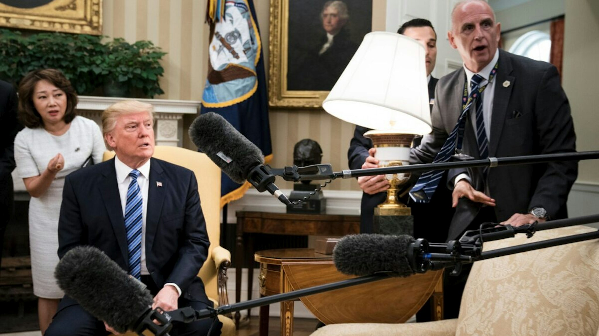 US President Donald Trump and Keith Schiller (R) react as a lamp is bumped by press before a meeting with South Korea'ss President Moon Jae-in in the Oval Office of the White House June 30, 2017 in Washington, DC.