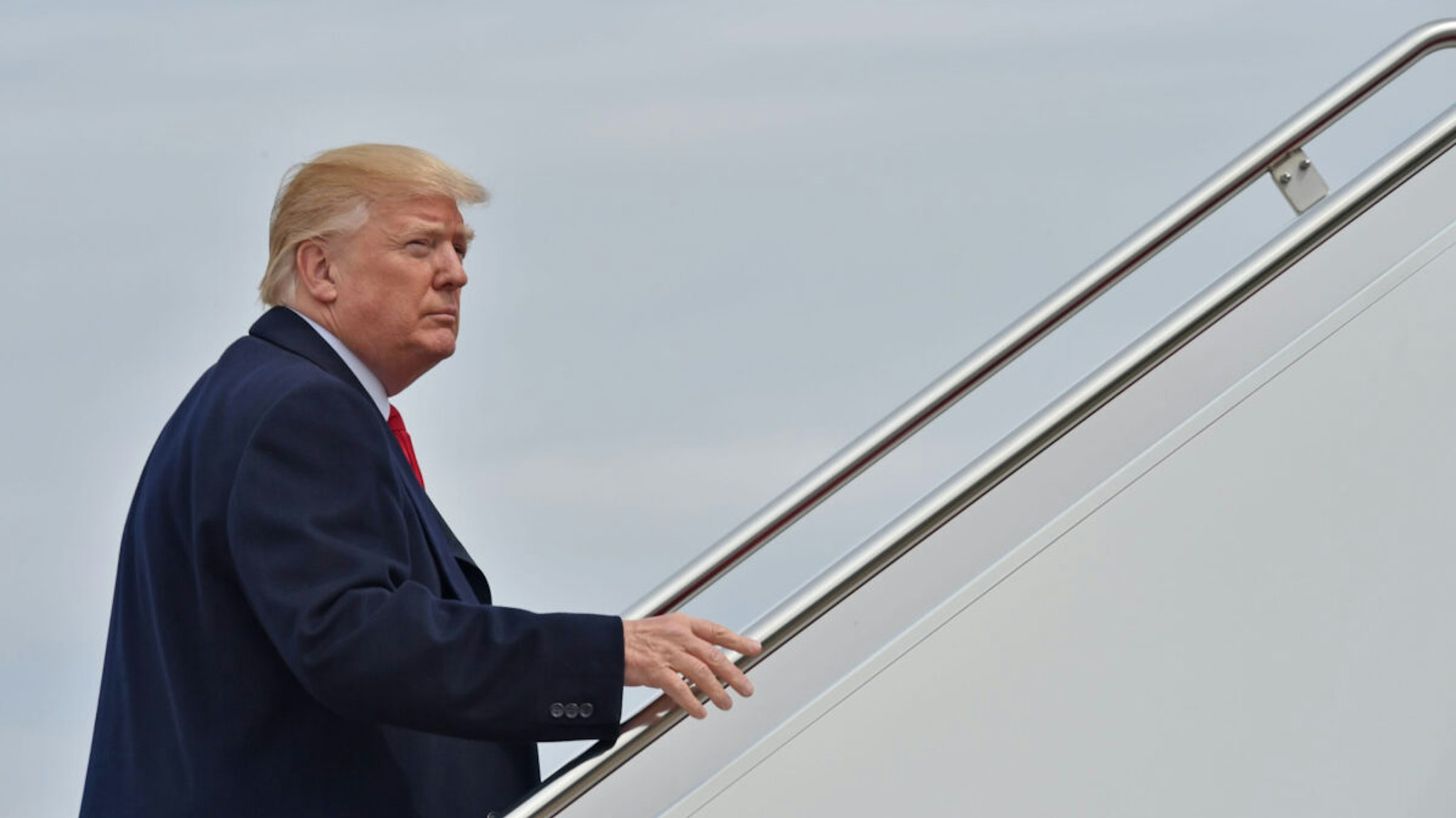 US President Donald Trump boards Air Force One at Andrews Air Force Base in Maryland on March 29, 2018, on his way to Cleveland.
