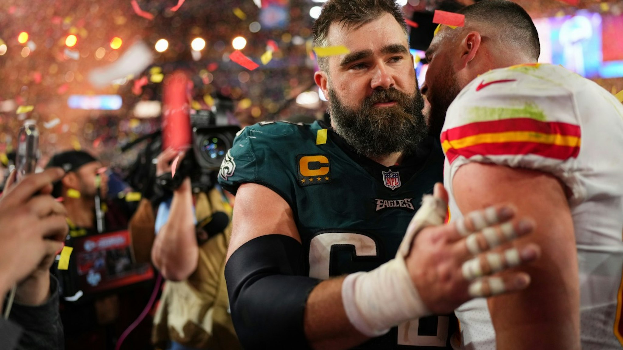 Jason Kelce #62 of the Philadelphia Eagles speaks with Travis Kelce #87 of the Kansas City Chiefs after Super Bowl LVII at State Farm Stadium on February 12, 2023 in Glendale, Arizona.