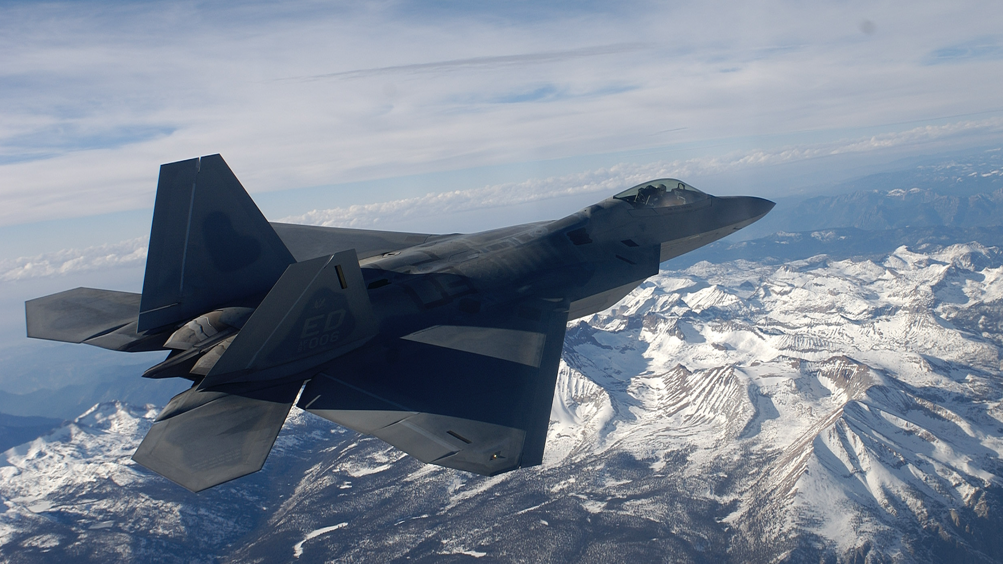 IN FLIGHT - NOVEMBER 23: The United States Air Force's F/A-22 Raptor, which will replace the F-15 bomber and is the first supersonic stealth fighter plane ever created flys over the Sierra Nevada Mountains November 23, 2002 in Northern California. The Raptor is said to be the most advanced plane ever designed and will be fully operational by 2005. Onboard is the new generation of smart computers that have made its advances possible. Whereas, for example, the Saturn V Rocket of 1967 had a computer onboard that ran on sixteen thousand lines of code, the Raptor's computer is programmed with two million lines of code. Because it stores it missiles and fuel inside its body, moreover, it has exceptionally low aerodynamic drag. Add to this low drag the fact that it is virtually impossible to detect the Raptor by radar until it is too close to fire on, and it is safe to say that the Raptor gives the US doiminance in the skies. Each plane has over one million parts and it takes one thousand Lockheed Martin technicians one month to build one in their facilities in Marietta, Georgia. With the Wright Brothers' historic flight celebrating its centennial in 2003, the world is now poised on the threshold of a new age in aviation, one where super-sonic jets refuel in flight, unmanned aerial vehicles track objects with astonishing accuracy, and airliners are maneuvered at times with minimal human participation. The computer age is about to revolutionize aviation and the United States is unquestionably ahead of the curve in this revolution.