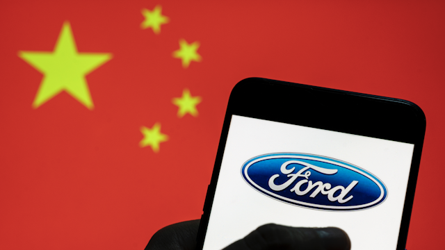CHINA - 2021/03/28: In this photo illustration the American multinational automaker Ford logo seen on an Android mobile device with People's Republic of China flag in the background.