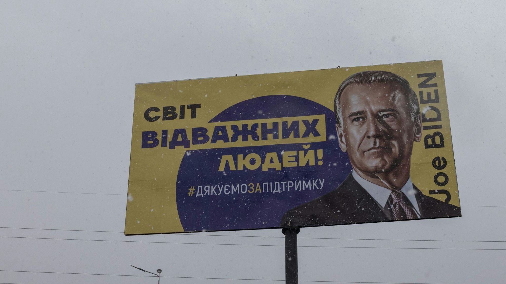 BUCHA, UKRAINE - FEBRUARY 1: A banner depicting U.S. President Joe Biden with Ukrainian words reading as: The world of brave people! #Thank you for the support, on February 1, 2023 in Bucha, outside Kyiv, Ukraine. February 24 will mark one year since Russia's large-scale invasion of Ukraine. In the time since, fighting has largely concentrated in the east and south of the country, but the capital remains the target of regular air strikes.