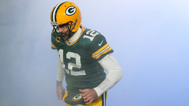 GREEN BAY, WISCONSIN - JANUARY 08: Aaron Rodgers #12 of the Green Bay Packers runs onto the field before a game against the Detroit Lions at Lambeau Field on January 08, 2023 in Green Bay, Wisconsin.