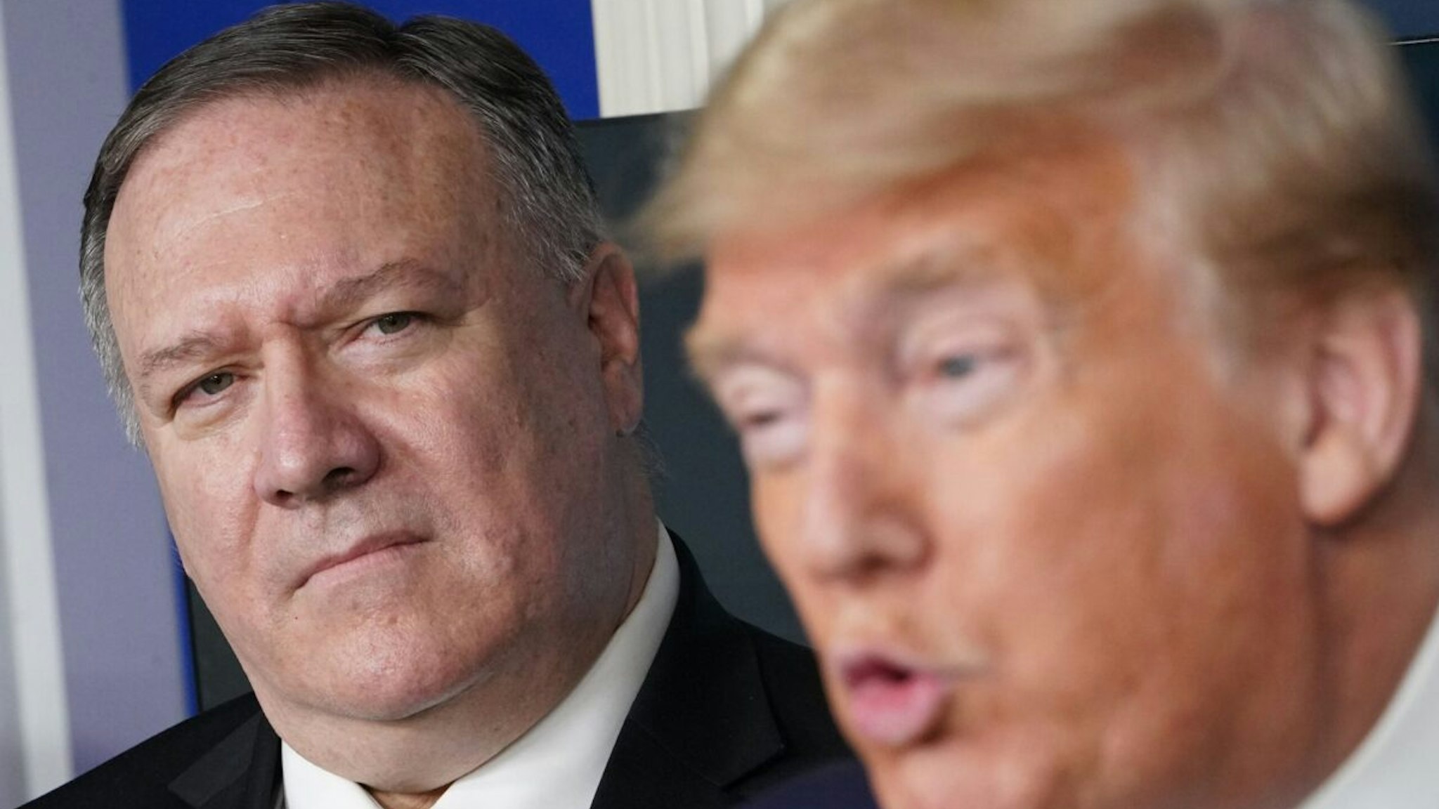 US Secretary of States Mike Pompeo listens as US President Donald Trump speaks during the daily briefing on the novel coronavirus, COVID-19, in the Brady Briefing Room at the White House on April 8, 2020, in Washington, DC.