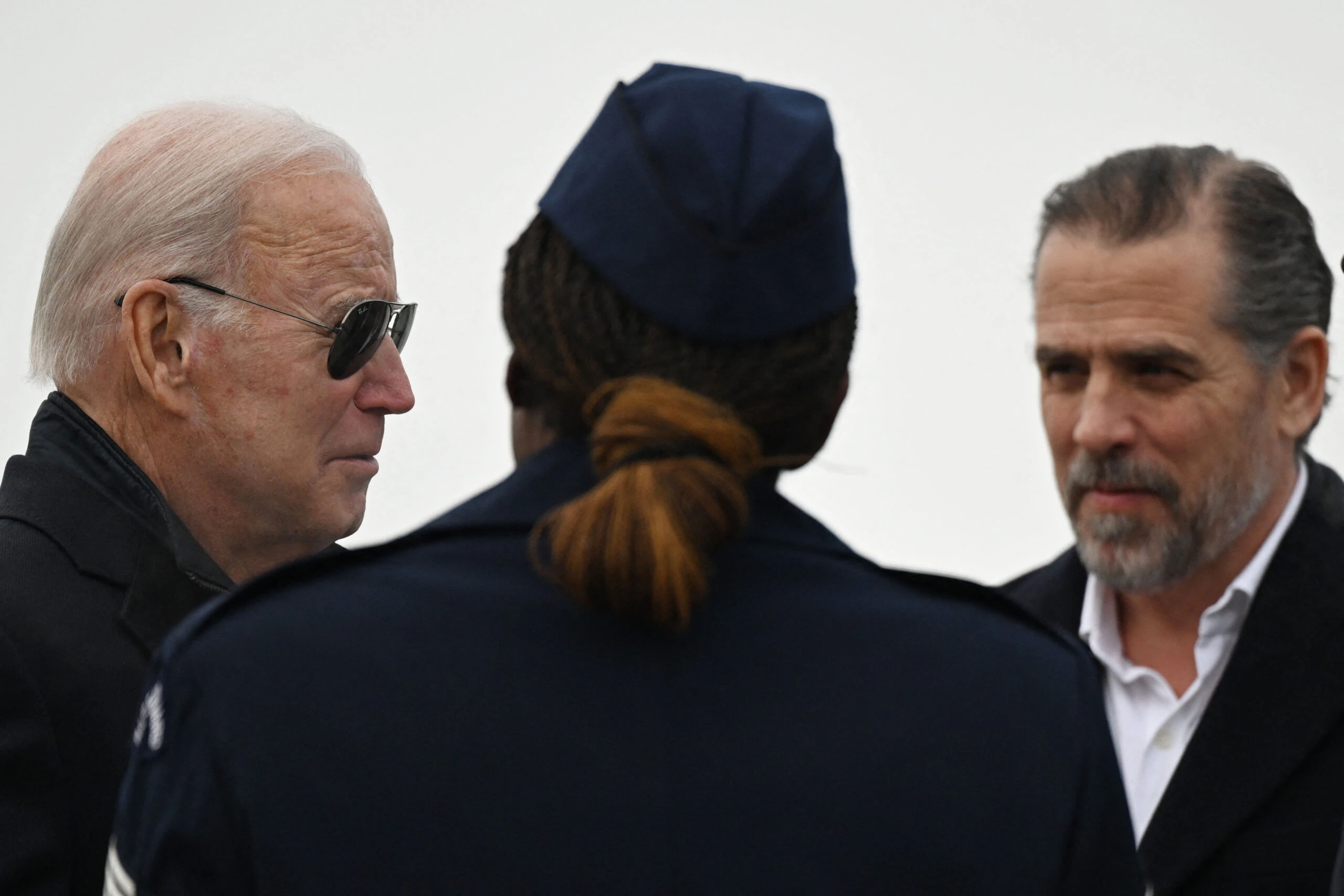 US President Joe Biden, with son Hunter Biden (R), speaks with Chief Master Sergeant Sonja Williams on arrival at Hancock Field Air National Guard Base in Syracuse, New York, on February 4, 2023.