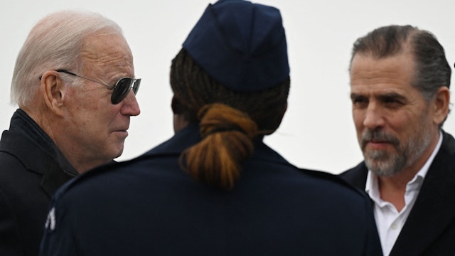 US President Joe Biden, with son Hunter Biden (R), speaks with Chief Master Sergeant Sonja Williams on arrival at Hancock Field Air National Guard Base in Syracuse, New York, on February 4, 2023.