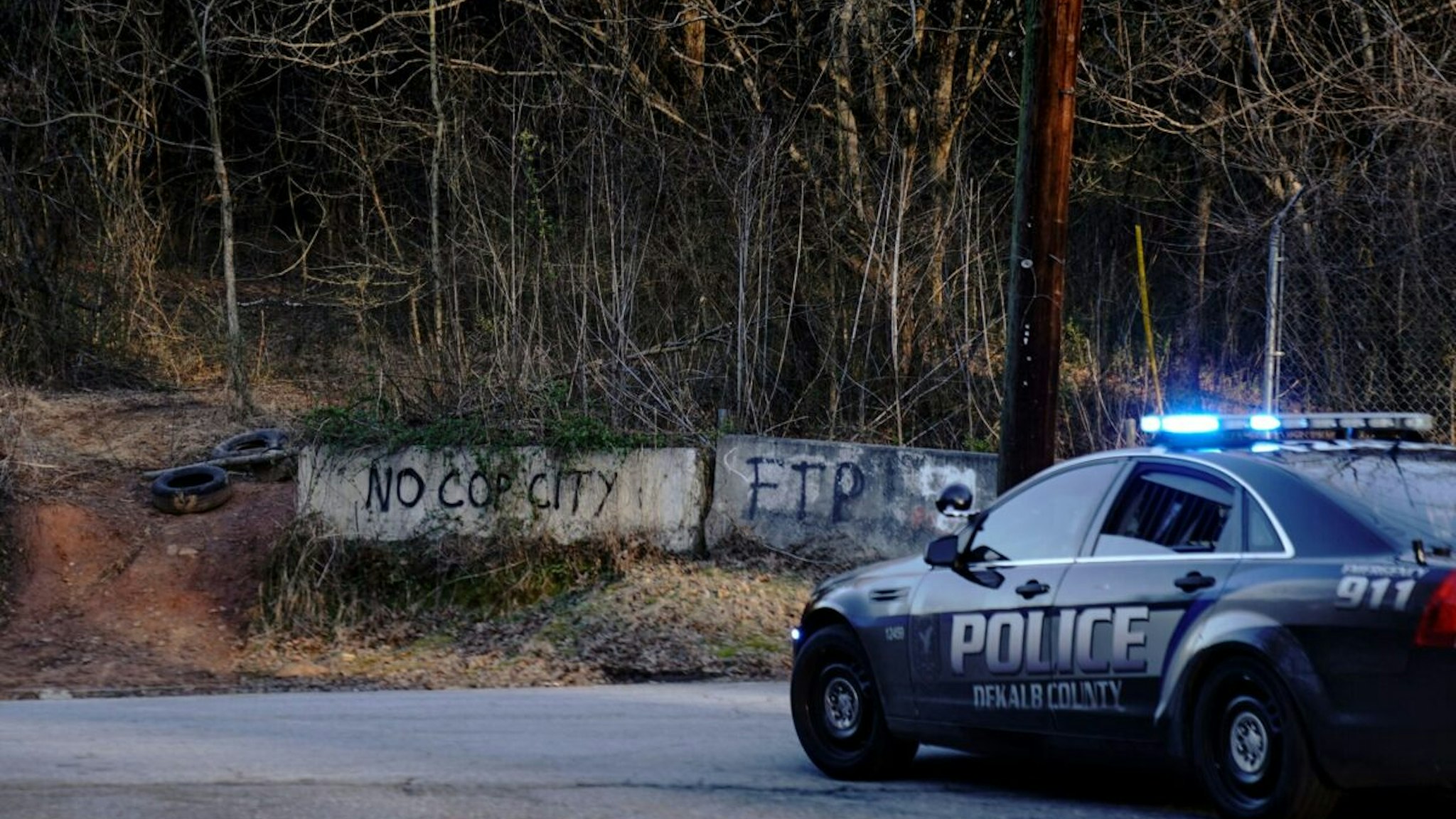 Law enforcement drive past the planned site of a police training facility that activists have nicknamed "Cop City", following the first raid since the death of environmental activist Manuel Teran near Atlanta, Georgia, on February 6, 2023.