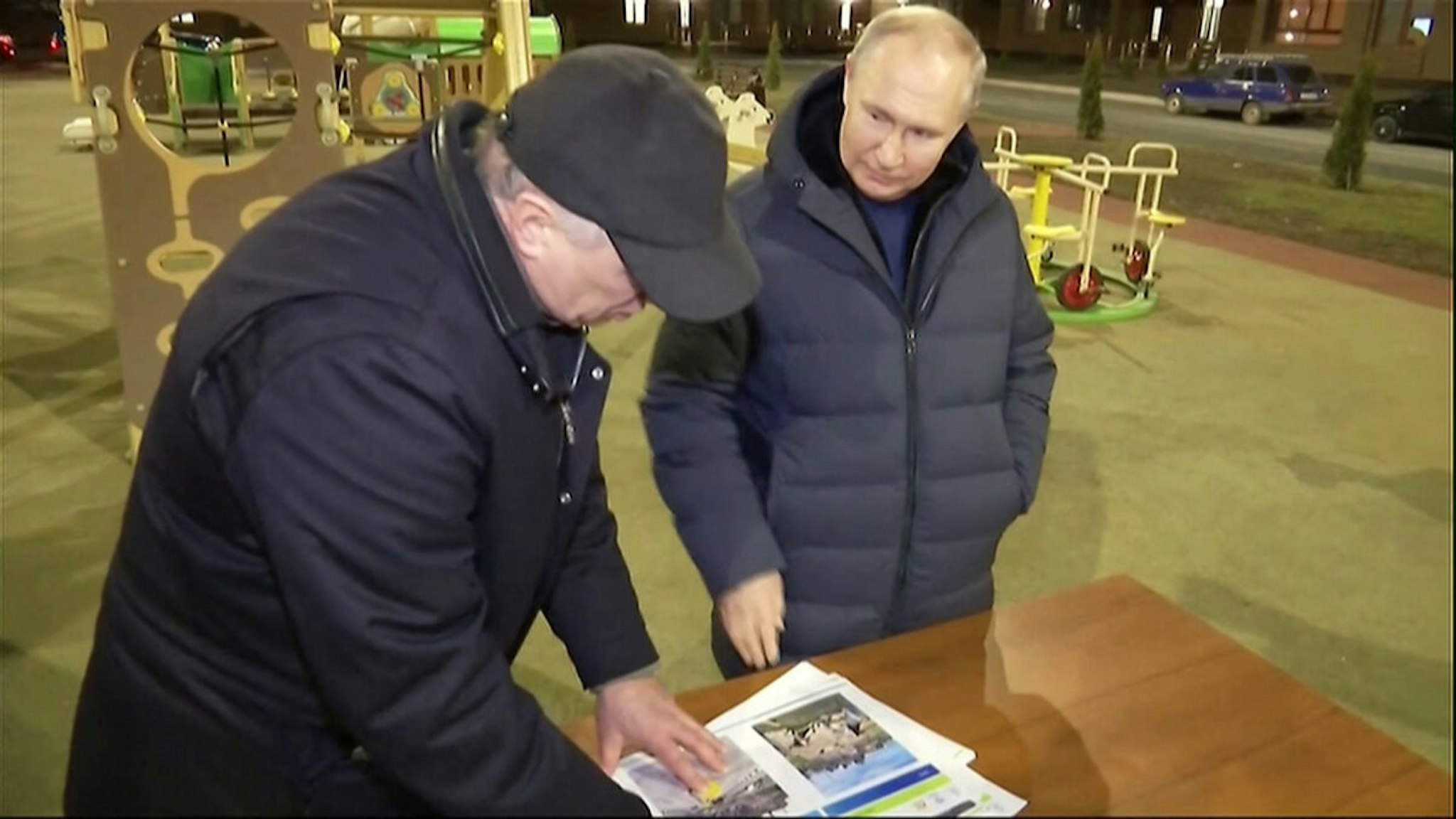 In this grab taken from video released by Russian broadcaster VGTRK as POOL on March 19, 2023, shows Russia's President Vladimir Putin (R) gesturing while speaking with Deputy Prime Minister Marat Khusnullin as they look at reconstruction illustrations while he visits the Ukranian city of Mariupol late March 18, 2023.