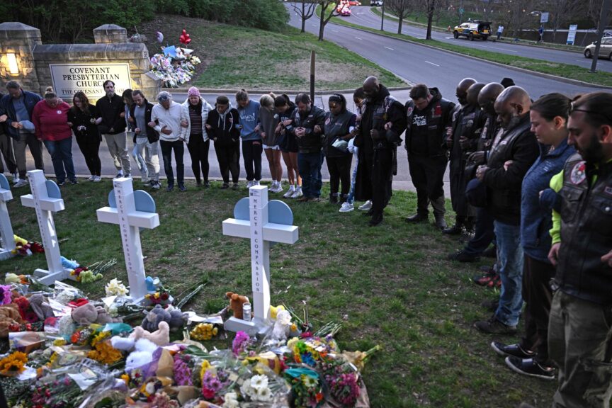 Members of the Selected First Motorcycle Club join others in prayer at a makeshift memorial for victims of a shooting at the Covenant School campus, in Nashville, Tennessee, March 28, 2023. - A heavily armed former student killed three young children and three staff in what appeared to be a carefully planned attack at a private elementary school in Nashville on March 27, 2023, before being shot dead by police. Chief of Police John Drake named the suspect as Audrey Hale, 28, who the officer later said identified as transgender.