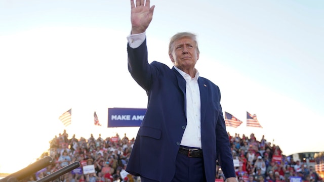 Former president Donald Trump gestures to the crowd during a campaign rally at Waco Regional Airport in Waco, Texas on Saturday, March 25, 2023.